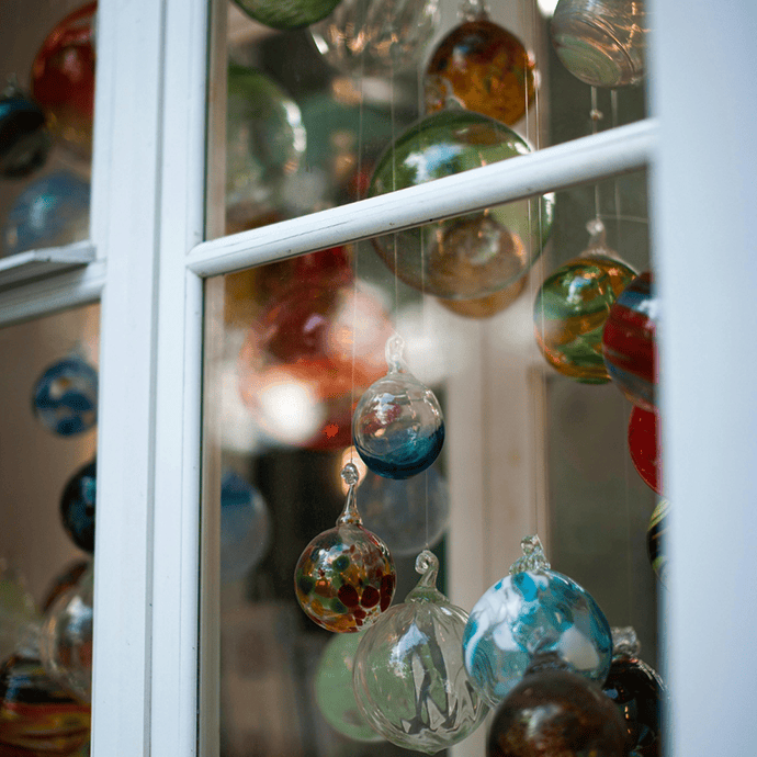 Christmas wedding baubles hanging in a window - Camellio Wedding Planning and Events - Essex Wedding Planner