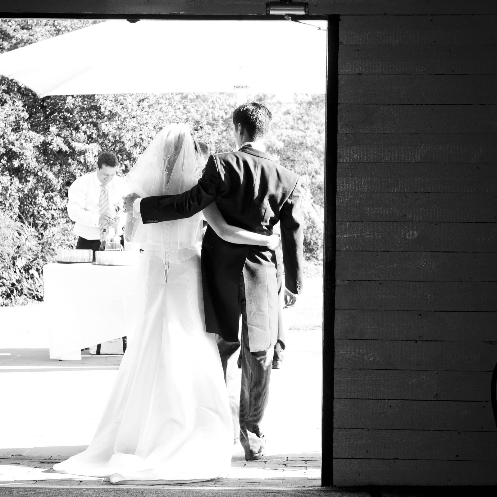Newly weds walking through a door way - Camellio Wedding Planning and Events - Essex Wedding Planner