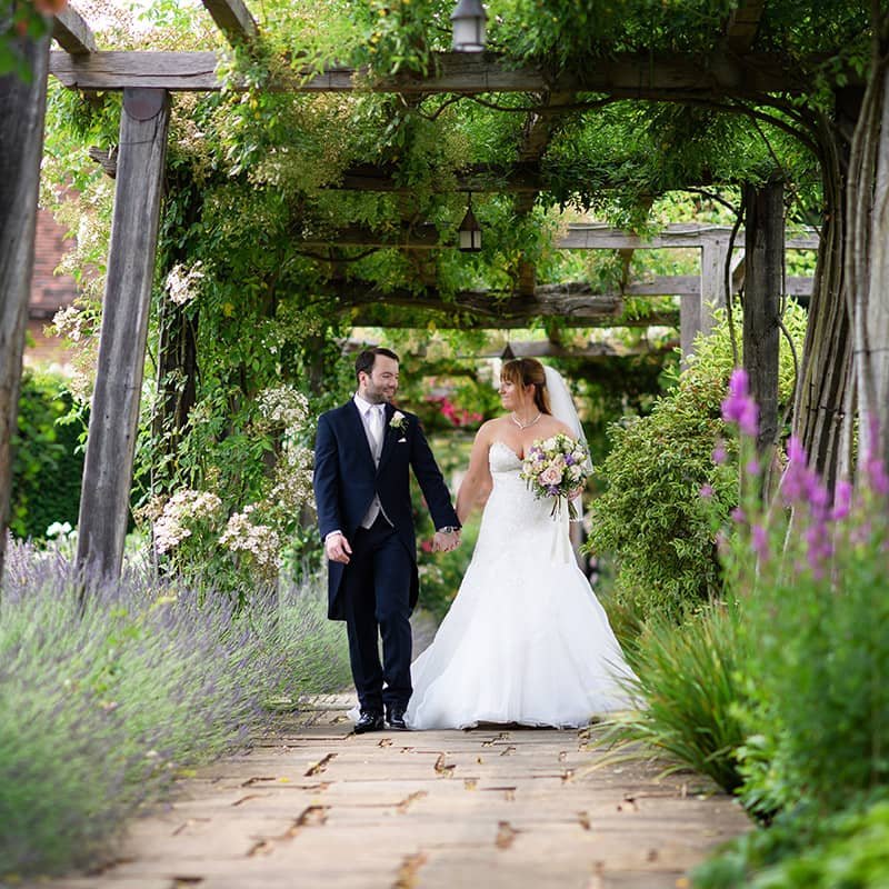 Wedding Couple walking in the garden - Camellio Wedding Planning and Events - Essex Wedding Planner