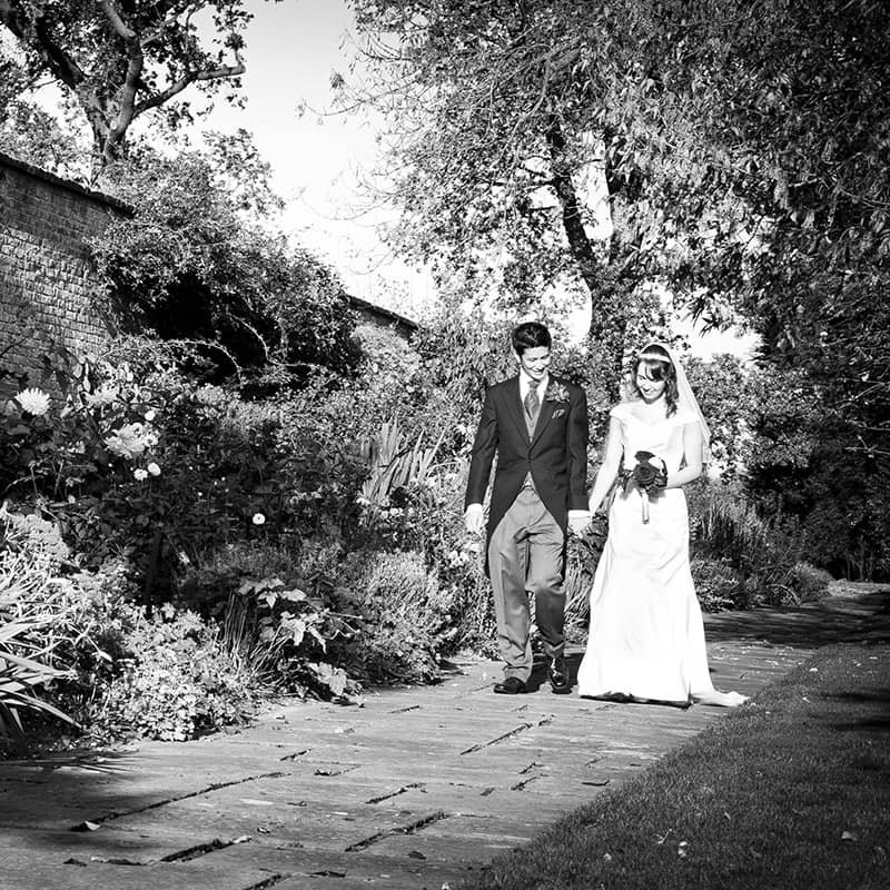 Bridal Couple Walking in Garden - Camellio Wedding Planning and Events - Essex Wedding Planner