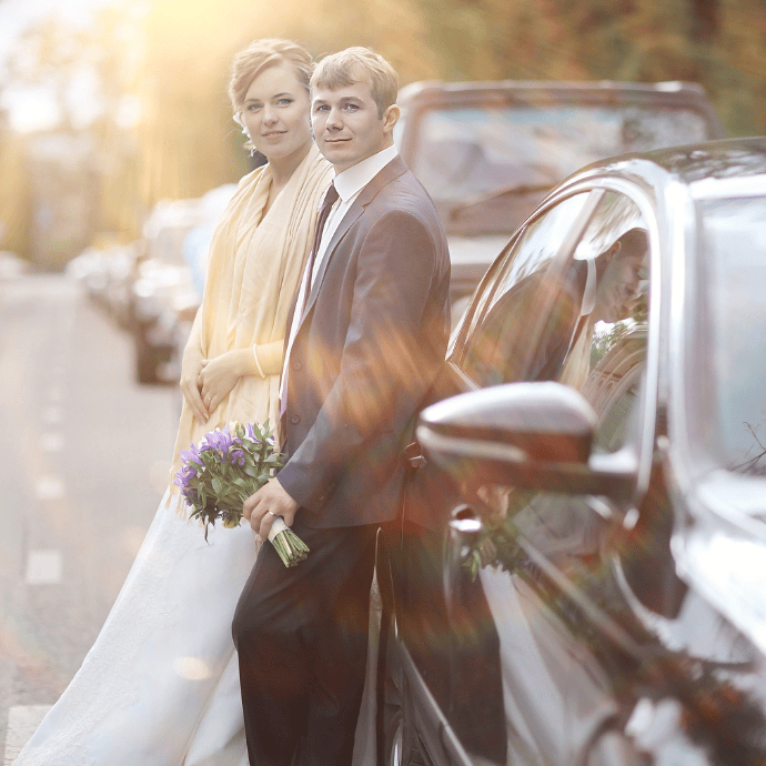 Wedding couple leaning on a wedding car- Camellio Wedding Planning and Events - Essex Wedding Planner